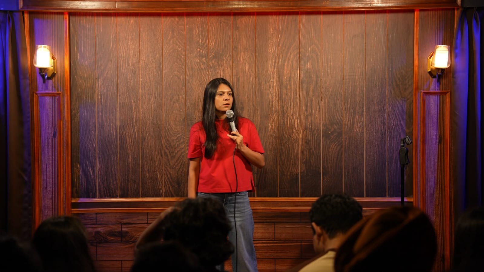 Stand-up comedian performing on stage at Highlane Comedy Club Noida